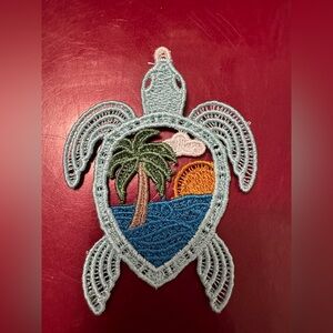 Turtle Embroidered free Standing Lace with Sunset Design.